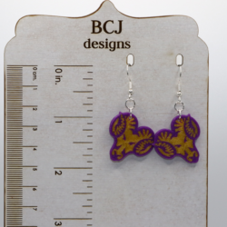 Pair of earrings featuring the West Chester Rams school logo in yellow and purple.