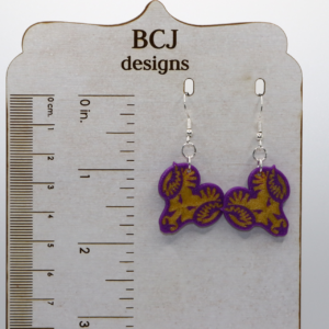 Pair of earrings featuring the West Chester Rams school logo in yellow and purple.