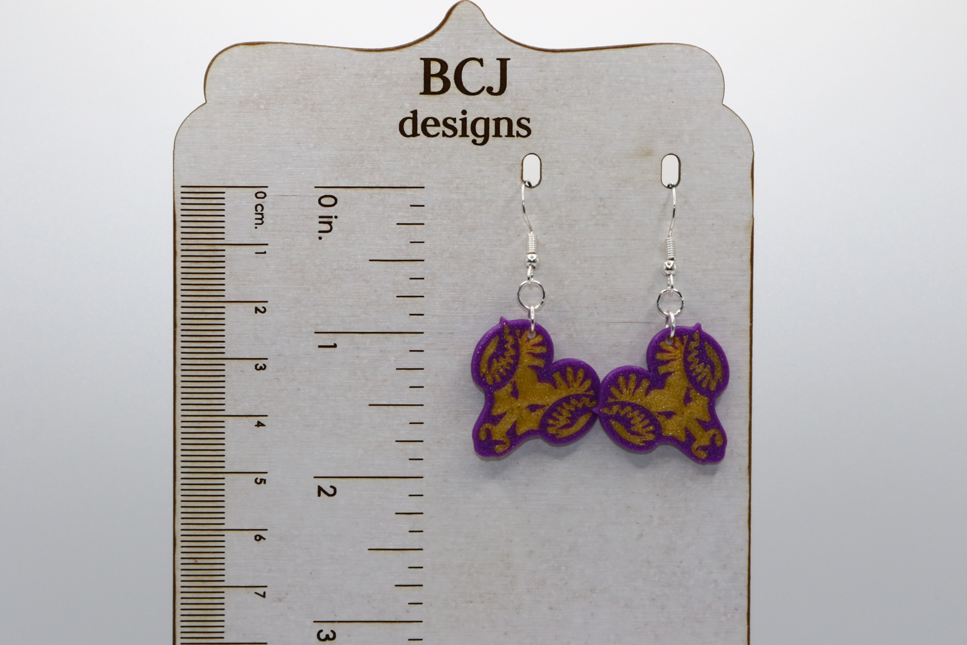 Pair of earrings featuring the West Chester Rams school logo in yellow and purple.