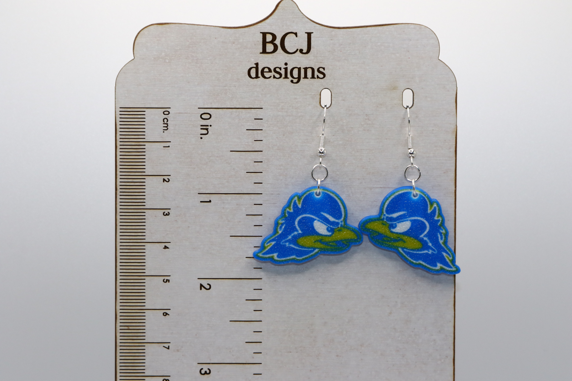 Pair of earrings featuring University of Delaware Hen mascot in blue and yellow.