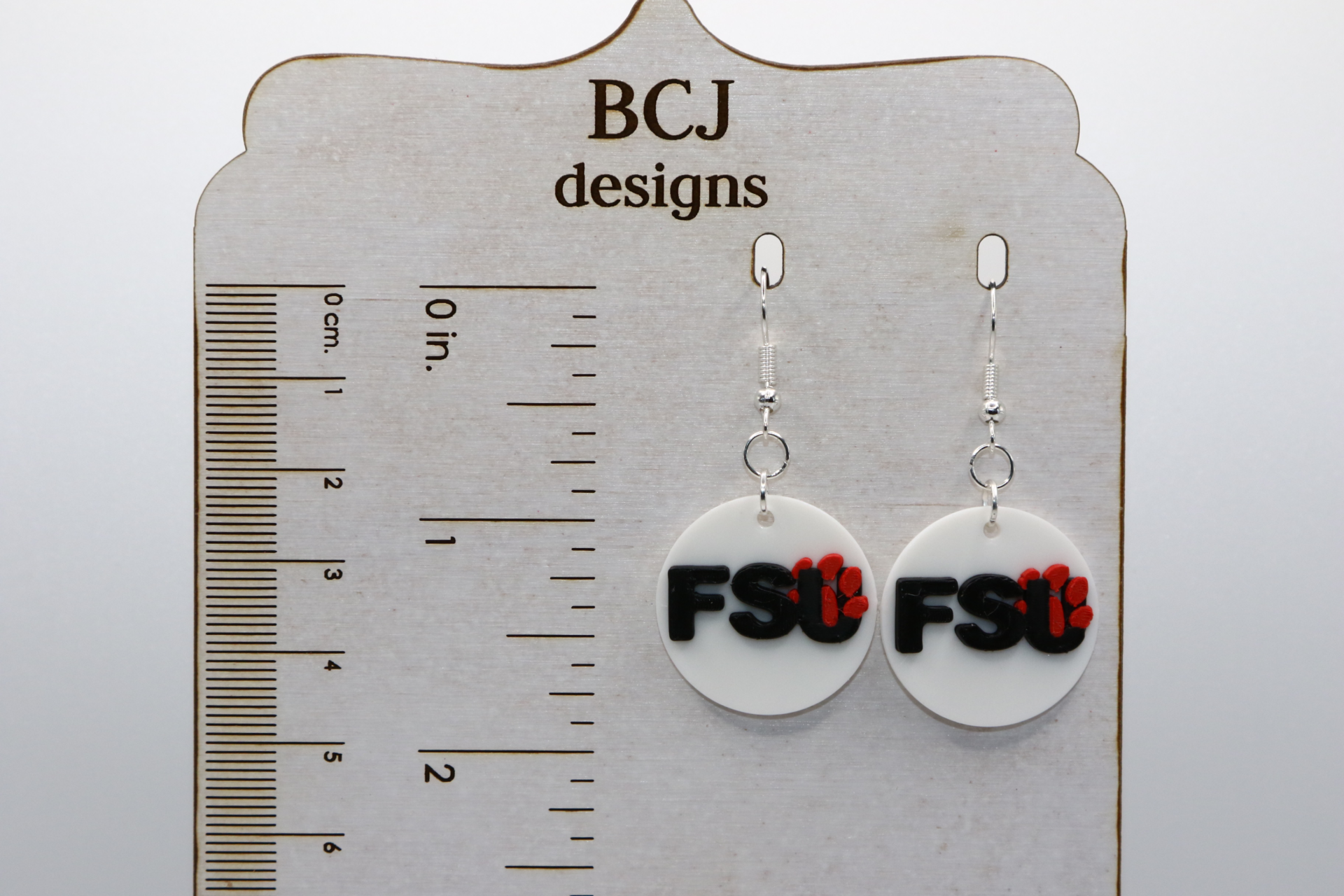 Pair of earrings featuring Florida State University Seminoles logo in garnet and gold.