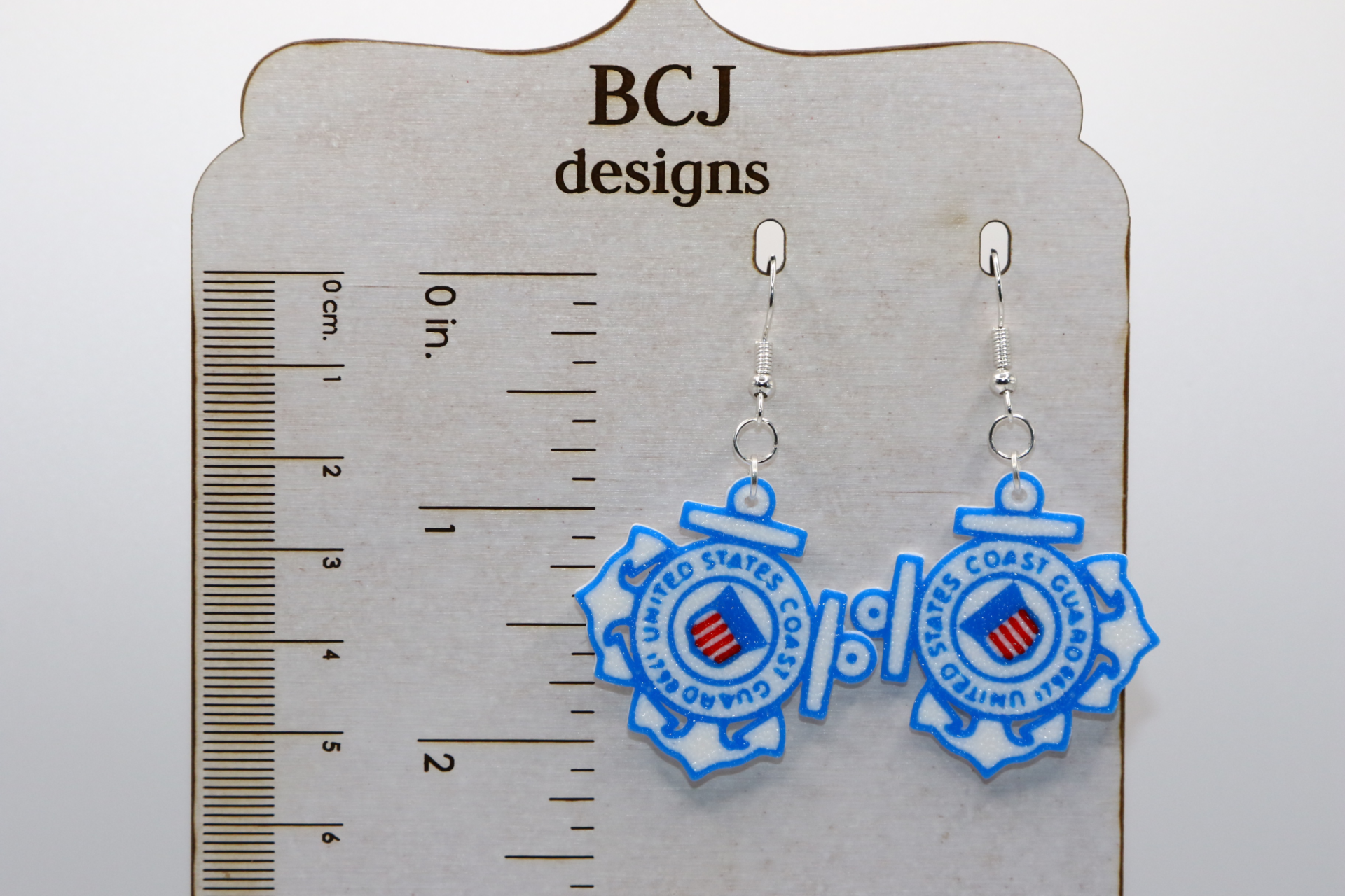 Pair of earrings featuring the U.S. Coast Guard emblem with red, white, and blue accents.