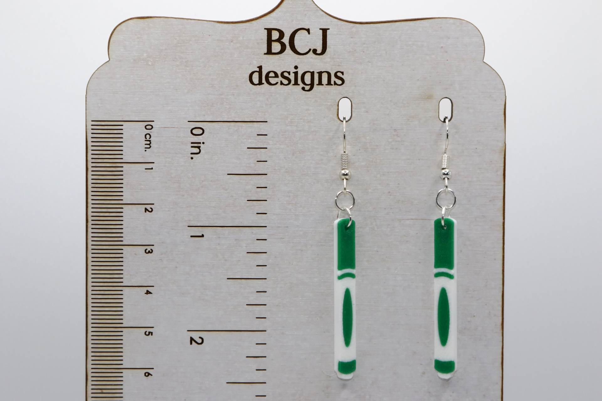 Pair of earrings featuring a set of colorful school markers in red, blue, green, and yellow.