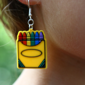 Pair of earrings featuring a colorful box of crayons with multiple hues.