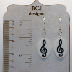 Set of earrings featuring treble, bass, alto, and tenor clef designs in a smooth silver finish.