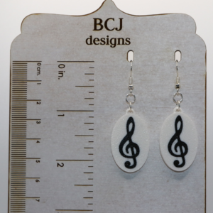 Set of earrings featuring treble, bass, alto, and tenor clef designs in a smooth silver finish.