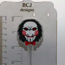 Jigsaw straw topper featuring detailed puppet face design.