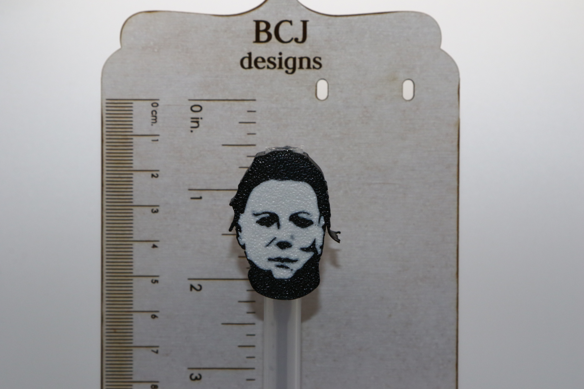 Michael Myers straw topper with white mask design.