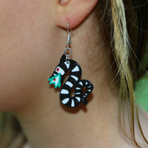 Pair of earrings featuring the Sandworm from Beetlejuice.