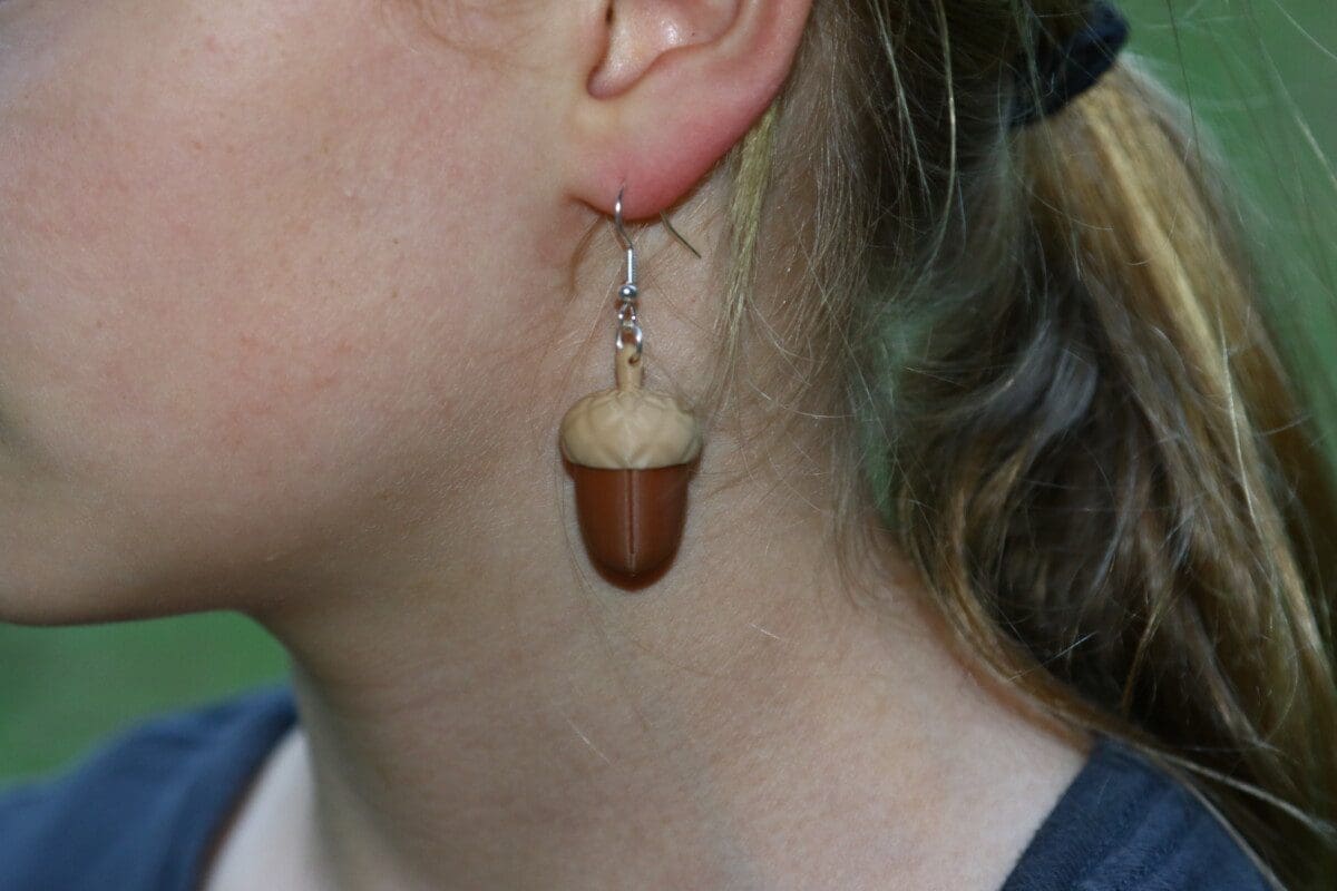 Acorn-shaped earrings in warm brown tones with natural detail.