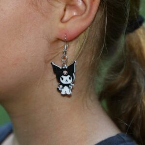 Kuromi earrings featuring black jester hat and pink skull detail.