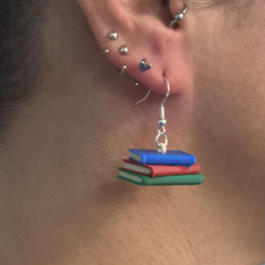 Pair of earrings featuring a stack of colorful books with detailed spines.