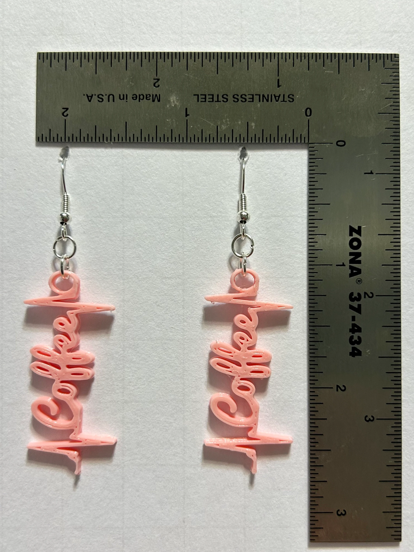Coffee heartbeat earrings with cup and heartbeat design.