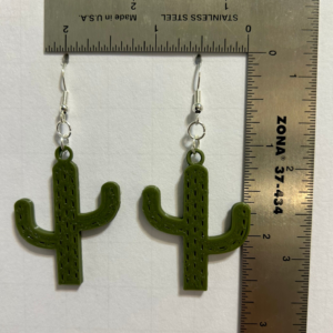 Green cactus-shaped earrings, festive Cinco de Mayo accessory.