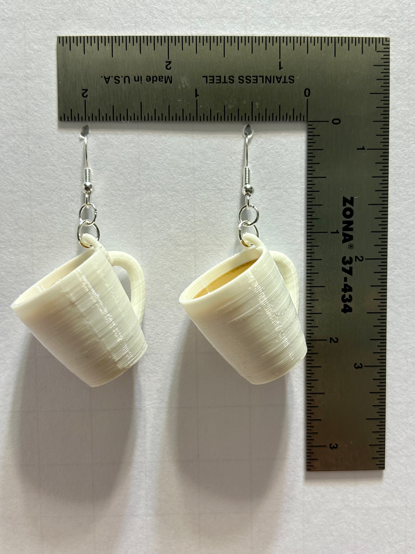 Coffee mug earrings with miniature detailed cup design.