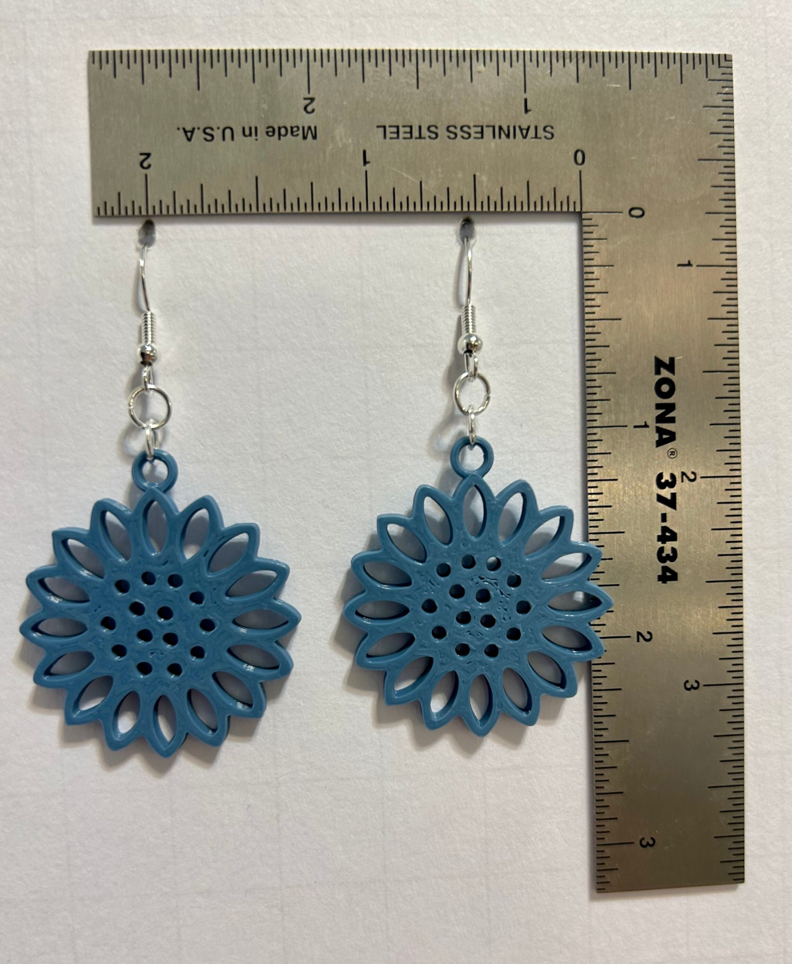 Single color daisy earrings with uniform petals and minimalist design.