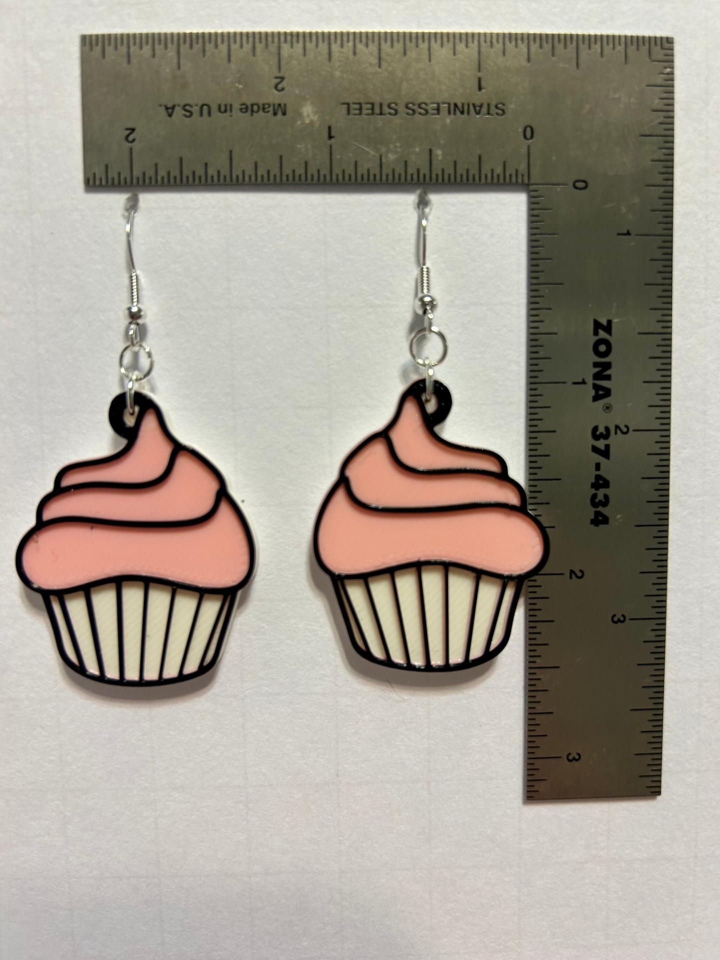 Cupcake earrings with colorful icing and sprinkles.