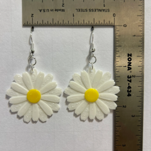 Daisy earrings featuring bright center and detailed petals.