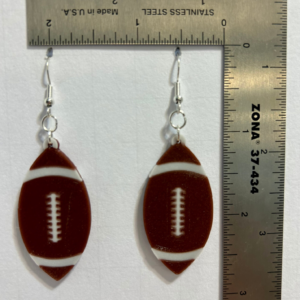 Pair of earrings shaped like a brown football with white stitching.