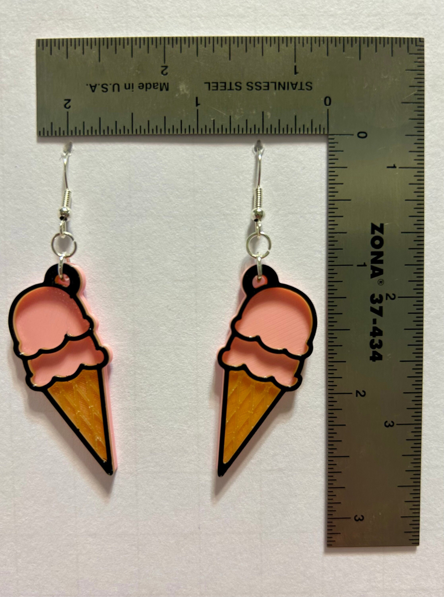 Ice cream cone earrings with detailed scoop and cone.