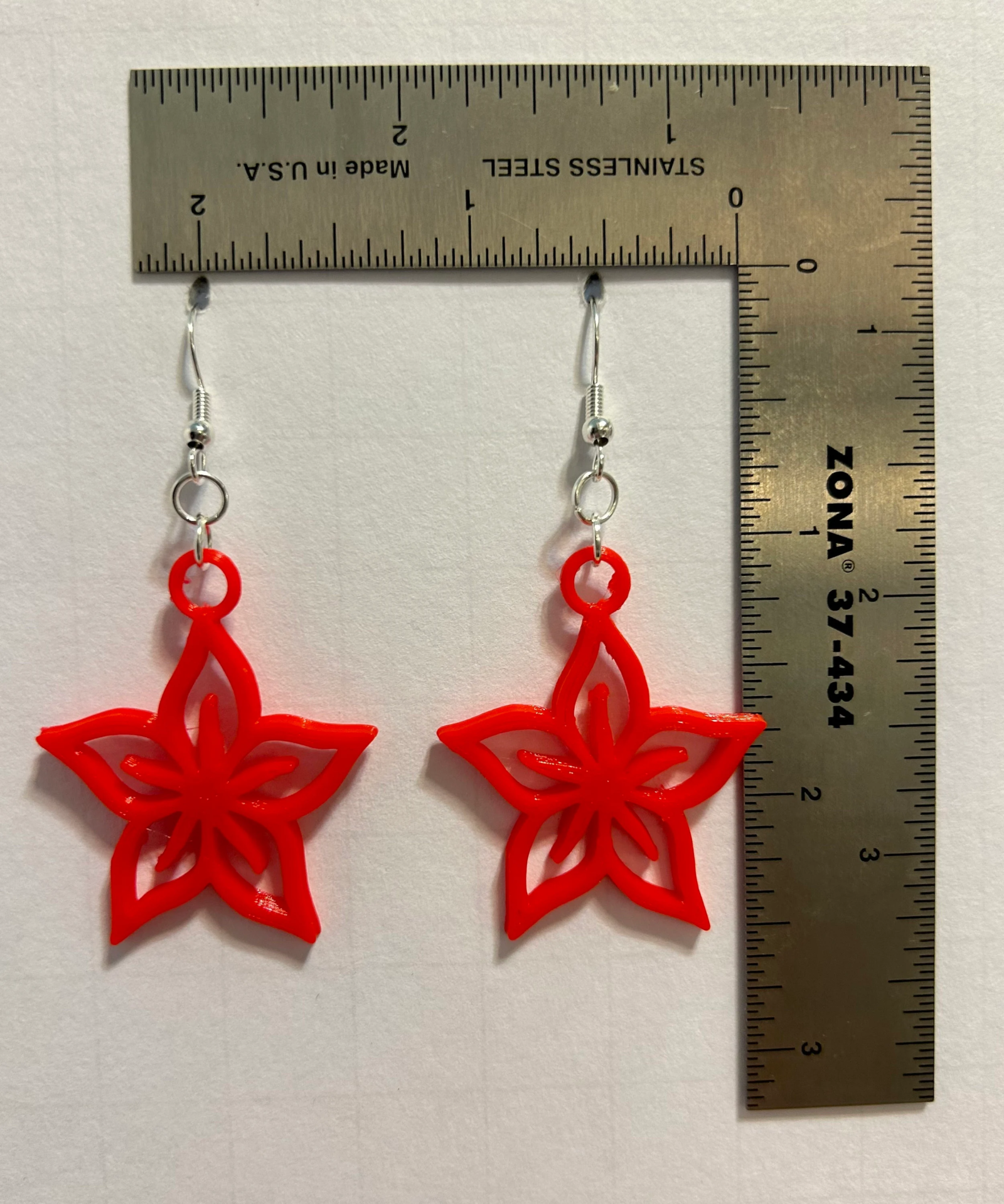 Plumeria earrings with layered petals and vibrant tropical colors.