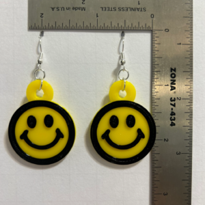 Pair of round yellow smiley face earrings with cheerful expressions.
