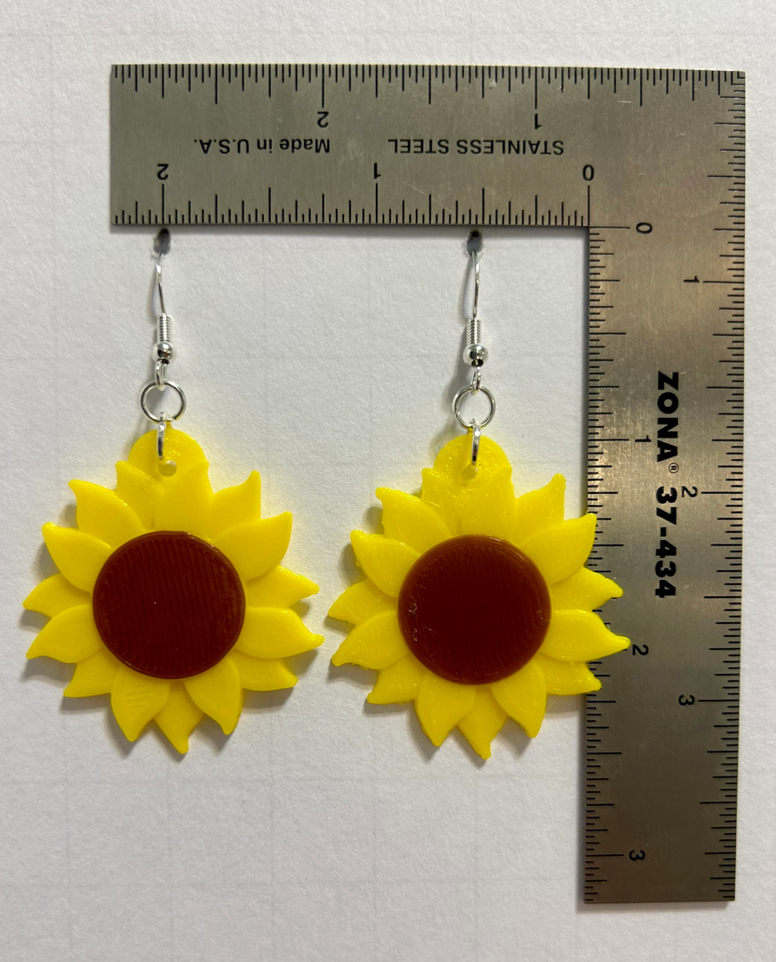 Sunflower earrings with vibrant yellow petals and detailed center.