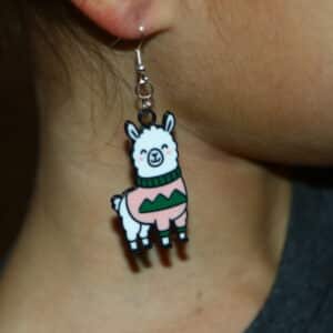 llama earrings wearing colorful ugly Christmas sweaters