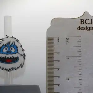 Bumble Stanley straw topper attached to a cup with colorful holiday details