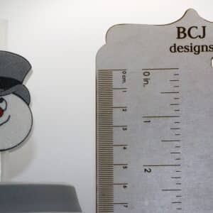 Frosty Stanley Straw Topper attached to a holiday mug with snowman details