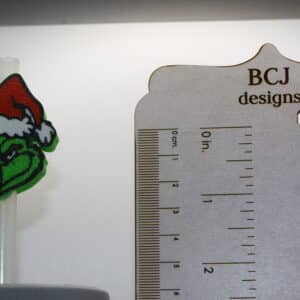 Grinch Stanley Straw Topper on a mug with vibrant holiday colors