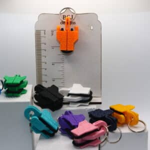 Hairtie Keychain clipped to a purse with hairtie inside, compact and durable design