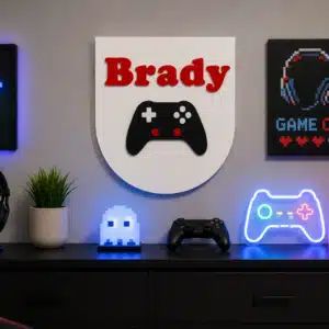 Personalized Gamer Name Sign featuring a custom child name above a modern game controller, 3D printed for gaming bedroom décor.