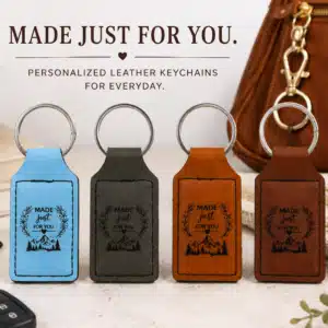 Four Personalized Premium Leatherette® keychains displayed in a stylish everyday lifestyle setting, showcasing custom laser engraved designs in multiple color options with everyday carry accessories.